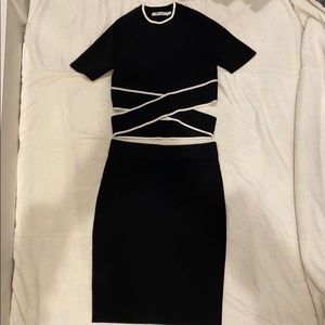 Black crop top and matching skirt with white trim